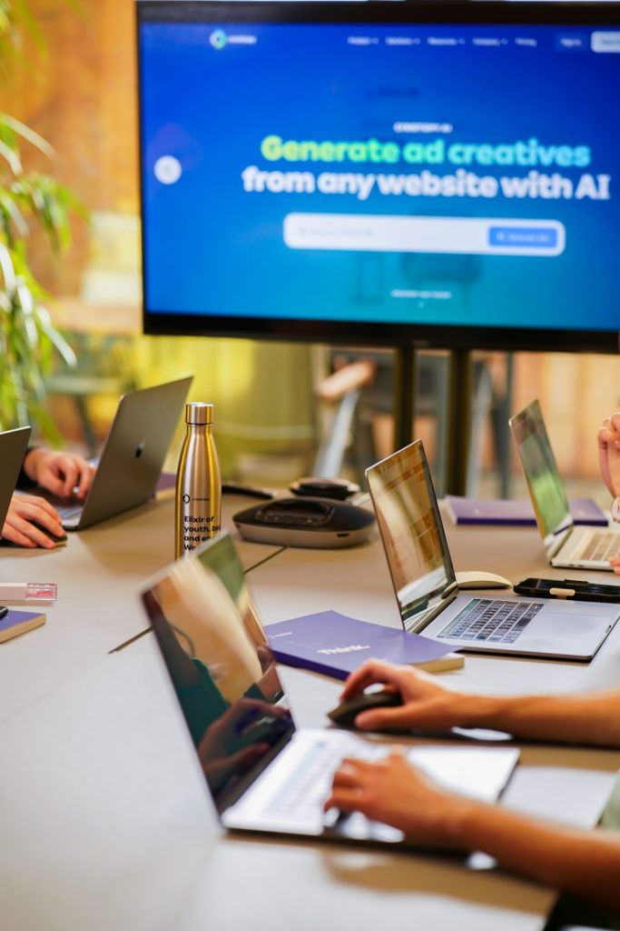 A tech startup is having a marketing meeting with coworkers and their laptops.